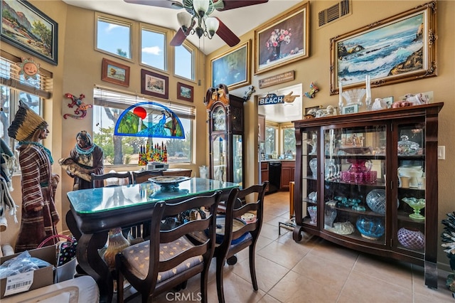 dining room featuring tile patterned flooring, ceiling fan, and vaulted ceiling