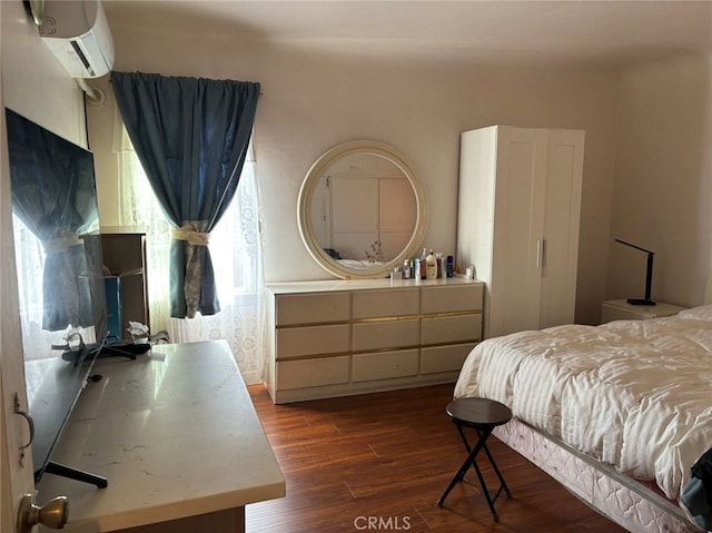 bedroom featuring dark hardwood / wood-style floors and a wall mounted air conditioner