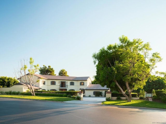 view of front of home featuring a garage and a front lawn