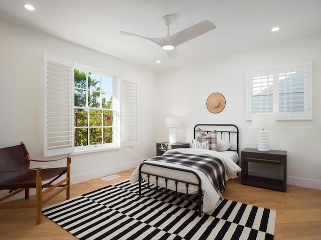 bedroom with ceiling fan and light hardwood / wood-style flooring