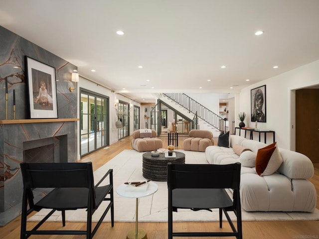 living room with a fireplace and light wood-type flooring