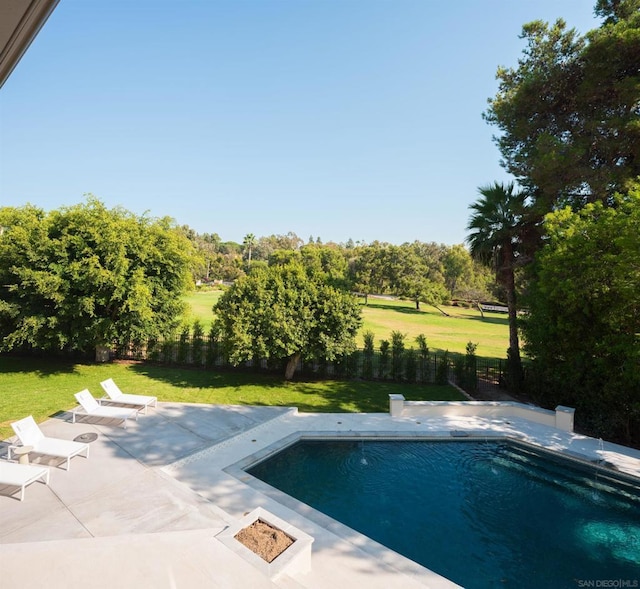 view of swimming pool with a yard and a patio