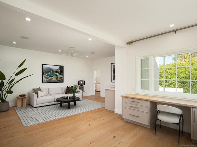 office featuring ceiling fan, light hardwood / wood-style floors, and built in desk