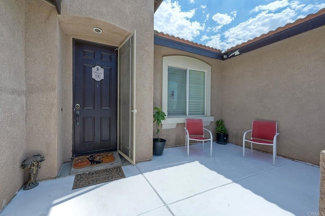 property entrance featuring a patio