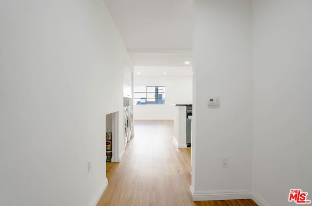 hall featuring washer / dryer and light hardwood / wood-style flooring