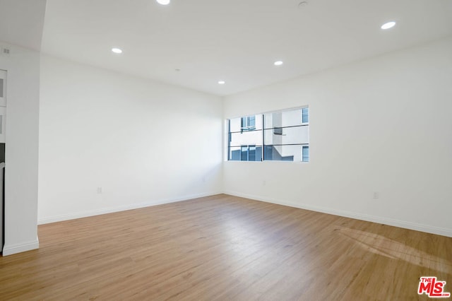 empty room with light hardwood / wood-style flooring