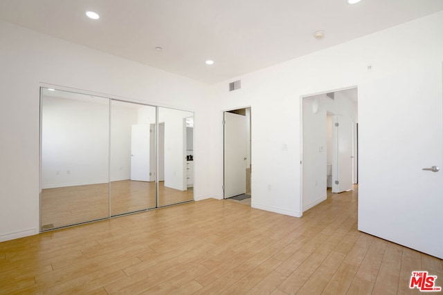 unfurnished bedroom featuring light wood-type flooring