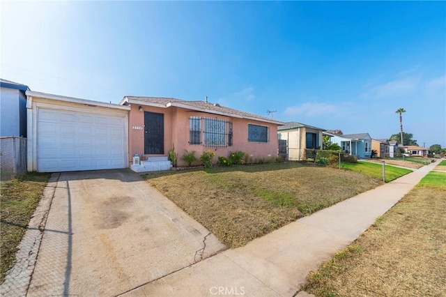 single story home with a front yard and a garage