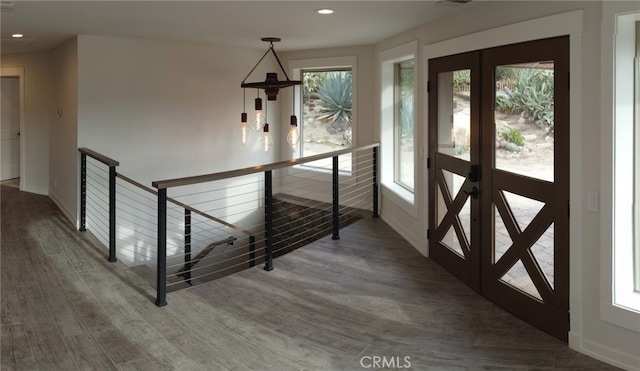 interior space with wood-type flooring, french doors, and plenty of natural light