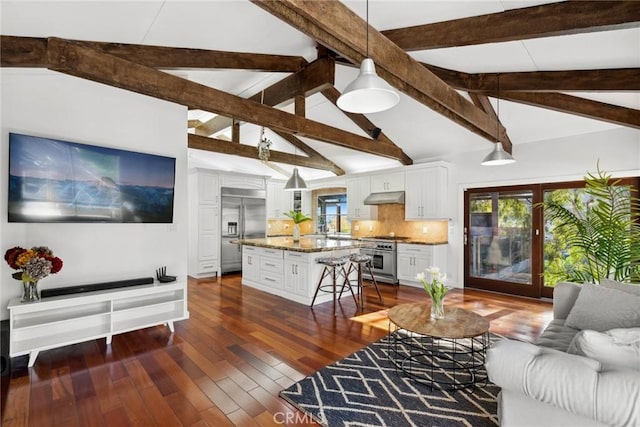 living room featuring lofted ceiling with beams and dark hardwood / wood-style flooring