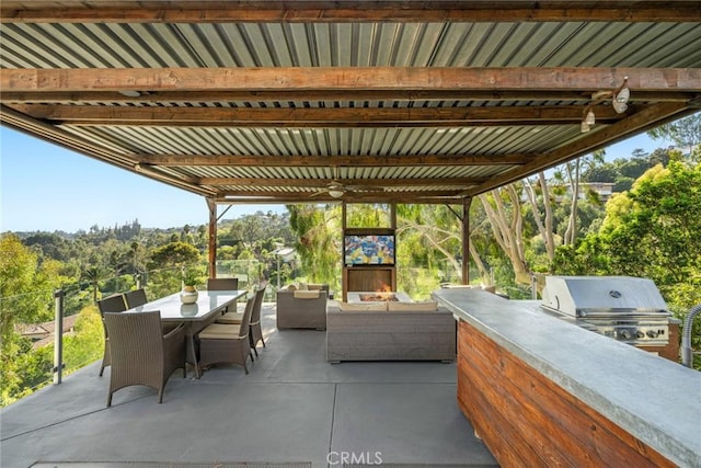 view of patio featuring area for grilling, ceiling fan, and an outdoor hangout area