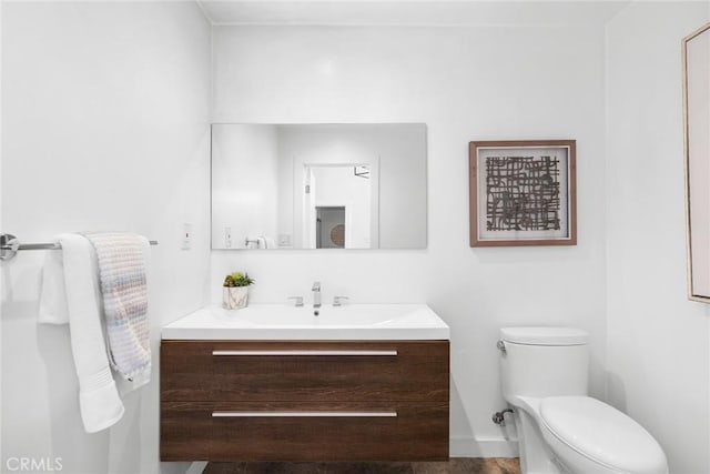 bathroom featuring vanity and toilet