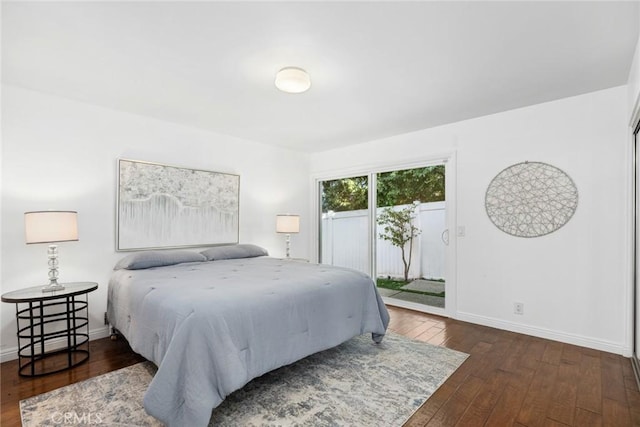 bedroom with dark wood-type flooring and access to outside