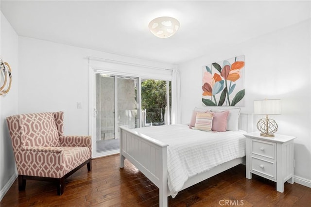 bedroom with dark wood-type flooring and access to outside