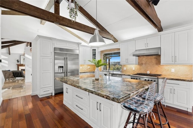 kitchen featuring built in refrigerator, beamed ceiling, white cabinets, and dark hardwood / wood-style floors