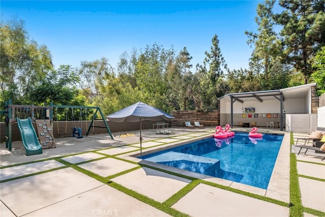 view of pool with a playground and a patio area