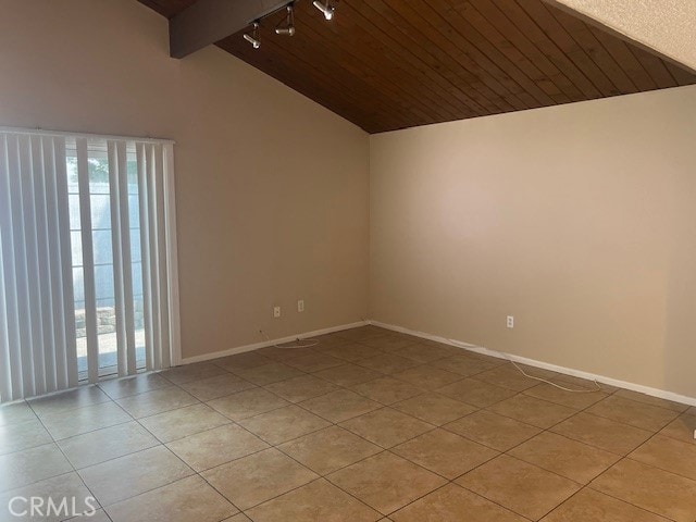 tiled spare room with vaulted ceiling with beams and wooden ceiling