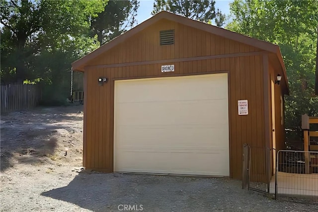 garage featuring wooden walls