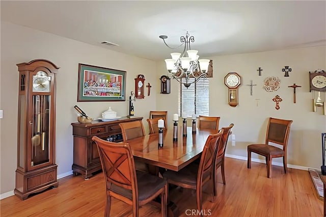 dining room with an inviting chandelier and light hardwood / wood-style floors