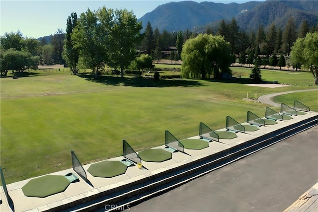 surrounding community with a lawn and a mountain view