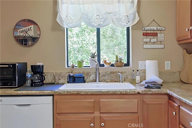 kitchen featuring white dishwasher and sink