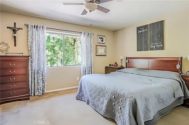 bedroom featuring ceiling fan and light colored carpet