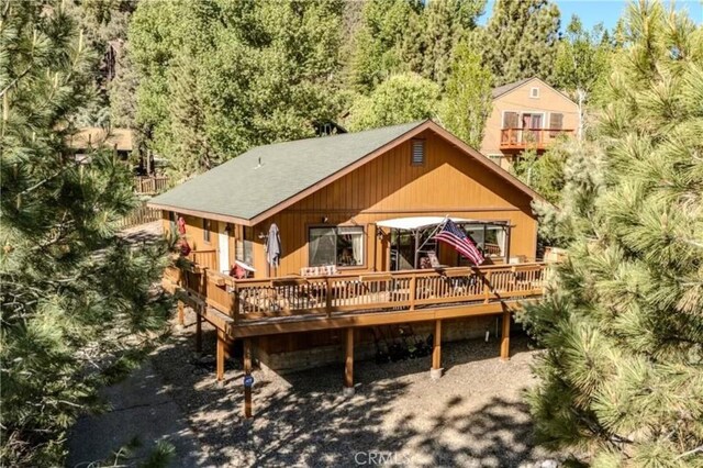 rear view of property featuring a wooden deck