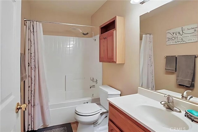 full bathroom featuring vanity, shower / bath combo with shower curtain, and toilet