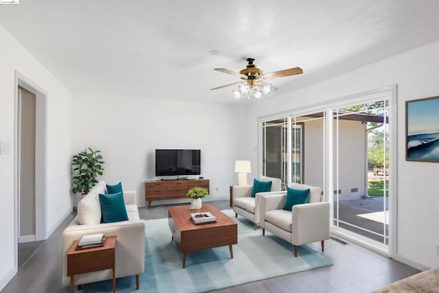 living room featuring hardwood / wood-style floors and ceiling fan