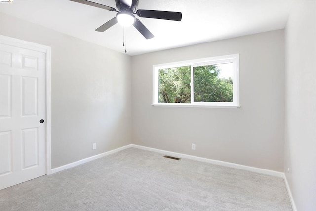 empty room featuring light carpet and ceiling fan