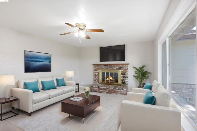 living room with a fireplace and ceiling fan