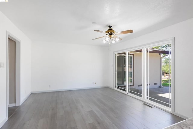 spare room featuring wood-type flooring and ceiling fan