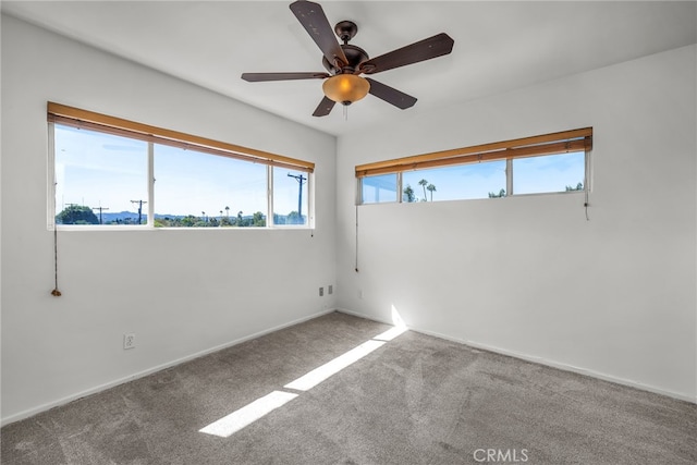 carpeted spare room with ceiling fan