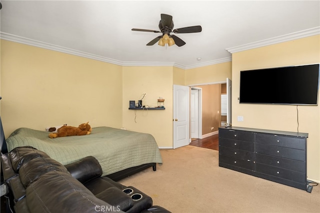 bedroom featuring crown molding, ceiling fan, and light colored carpet