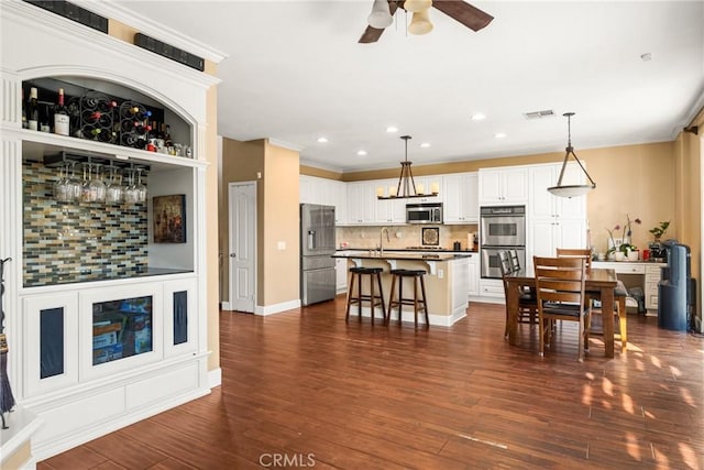 living area with recessed lighting, visible vents, a ceiling fan, and dark wood-style floors