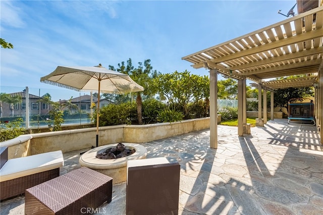 view of patio / terrace featuring a pergola, a water view, and an outdoor fire pit