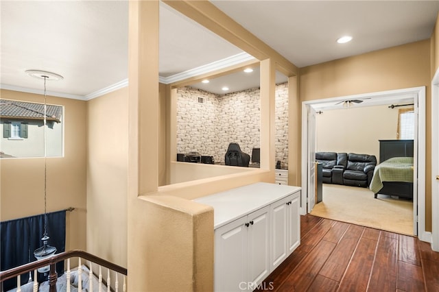 hallway featuring dark wood-type flooring and crown molding