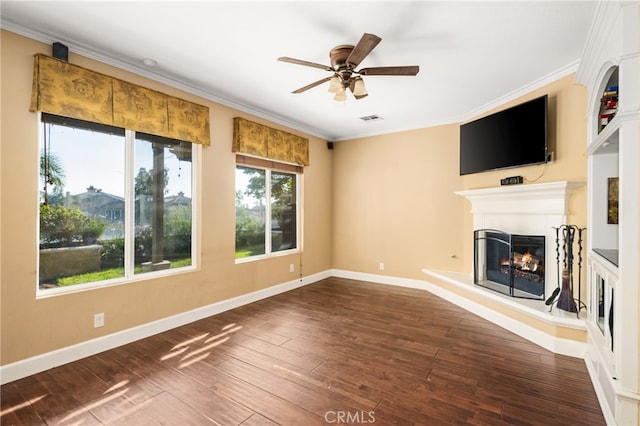 unfurnished living room featuring ornamental molding, ceiling fan, and dark hardwood / wood-style floors