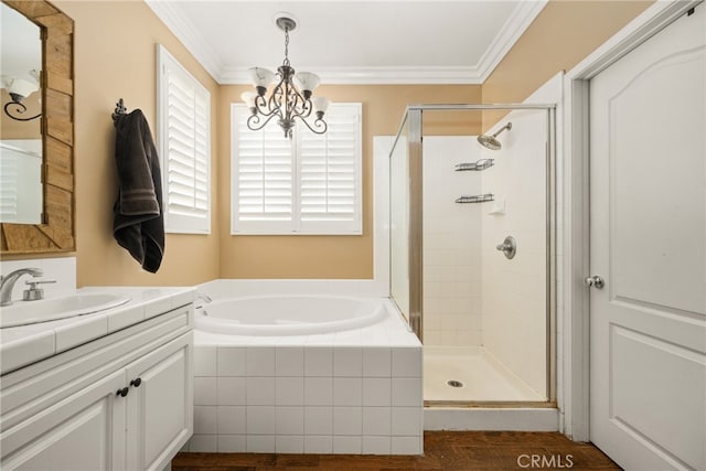 bathroom featuring shower with separate bathtub, a chandelier, wood-type flooring, ornamental molding, and vanity