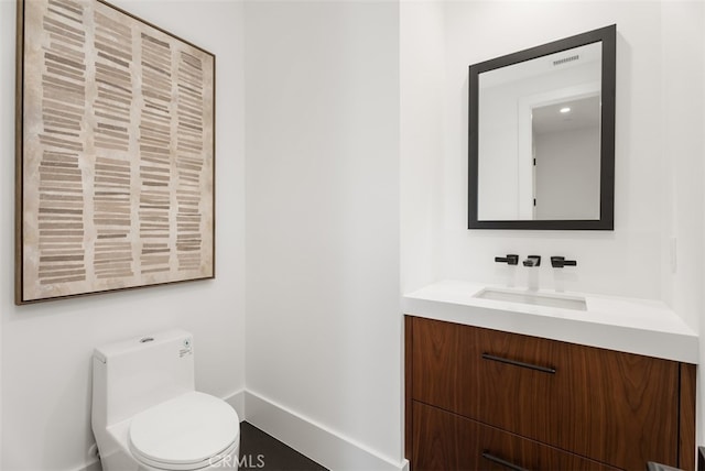 bathroom with vanity and toilet