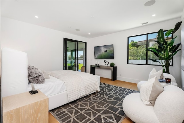 bedroom featuring hardwood / wood-style flooring and access to exterior