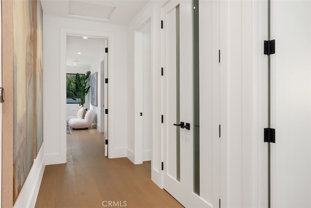 corridor with light hardwood / wood-style flooring