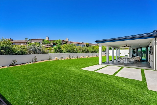 view of yard with a patio and ceiling fan