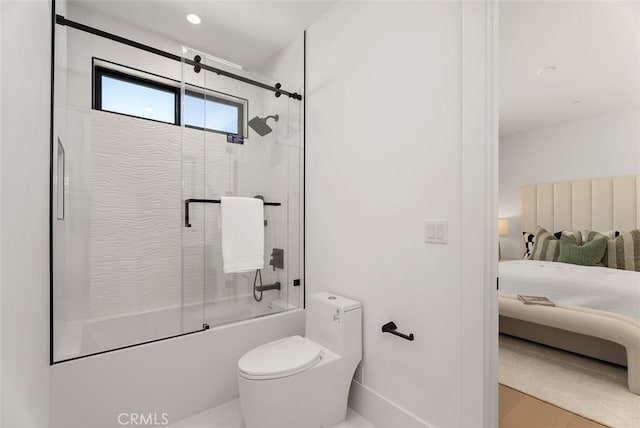 bathroom featuring shower / bath combination with glass door and toilet