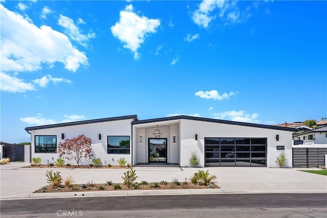 32531 Azores Rd, Dana Point, CA 92629 - modern home featuring stucco siding, concrete driveway, a garage, and fence