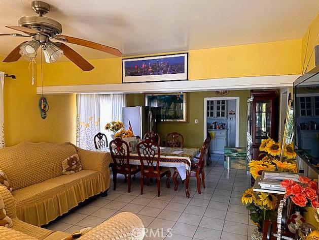 dining space featuring light tile patterned floors and ceiling fan