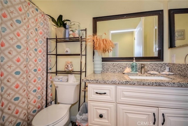 bathroom featuring vanity, toilet, and a shower with shower curtain