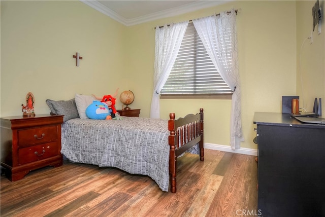 bedroom featuring crown molding and hardwood / wood-style floors