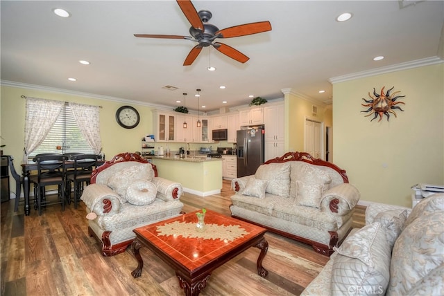 living room featuring ornamental molding, ceiling fan, and hardwood / wood-style floors