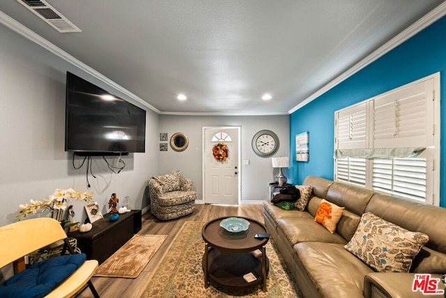 living room featuring hardwood / wood-style floors and ornamental molding